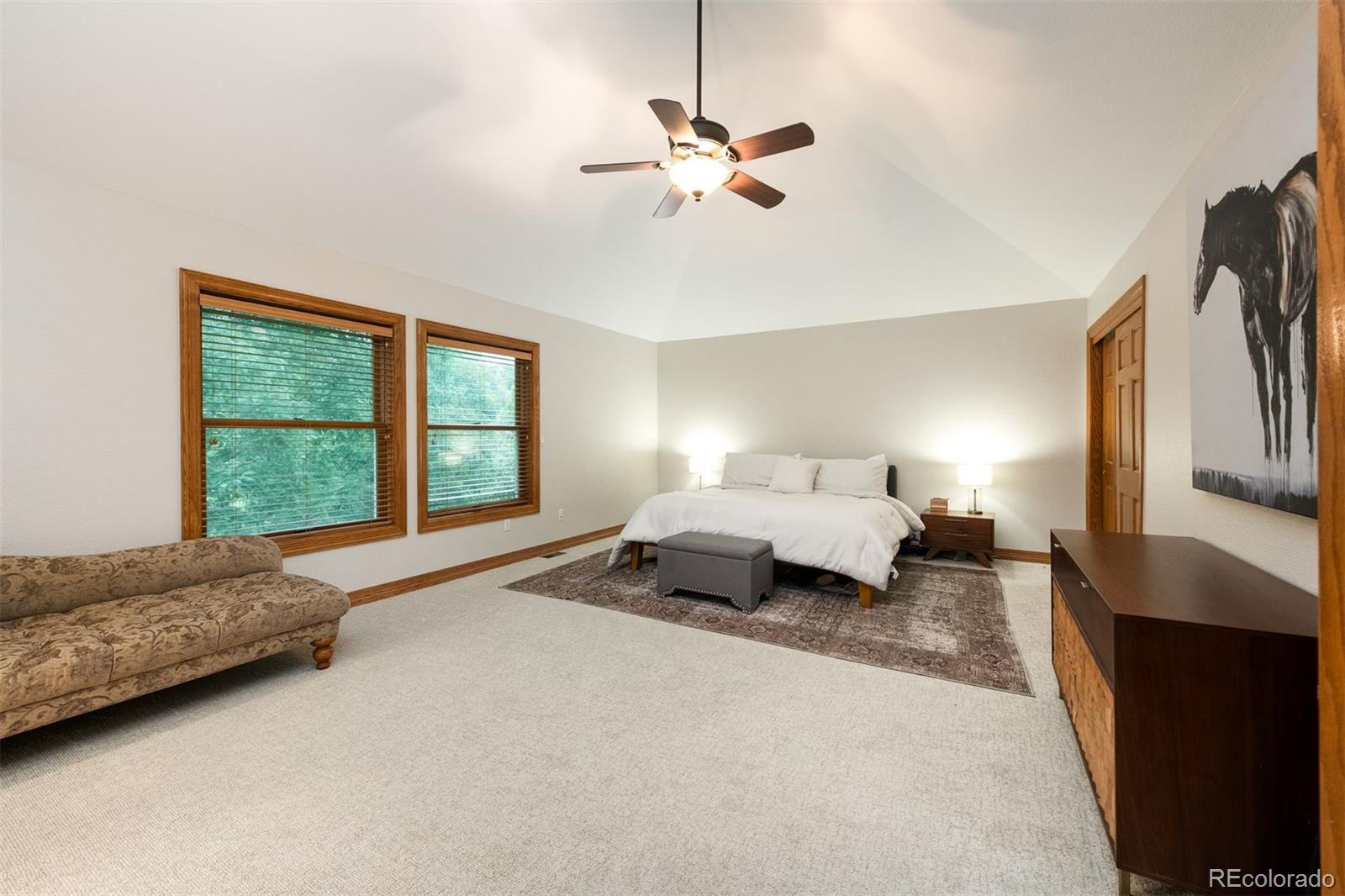 3935 Pierson Street Wheat Ridge, CO 80033 - Photo 23 of 50 a spacious bedroom with a bed a couch and a window