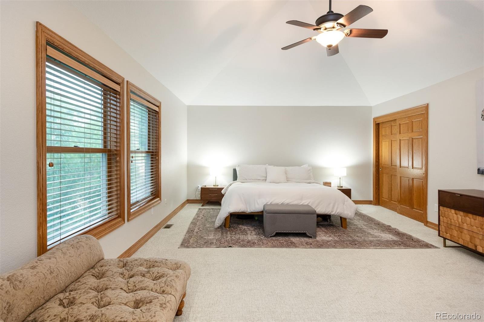 3935 Pierson Street Wheat Ridge, CO 80033 - Photo 24 of 50 a bedroom with a large bed and a chandelier