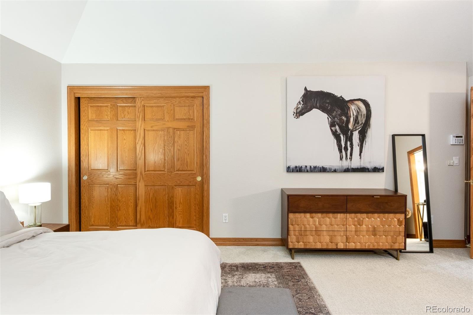3935 Pierson Street Wheat Ridge, CO 80033 - Photo 25 of 50 a bedroom with a bed and a painting on the wall