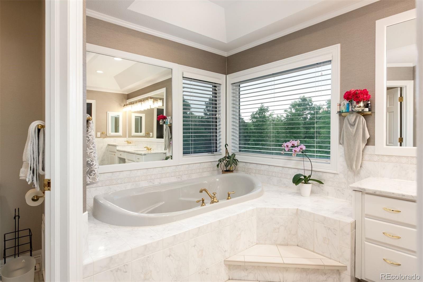 3935 Pierson Street Wheat Ridge, CO 80033 - Photo 27 of 50 a bathroom with a tub sink and mirror