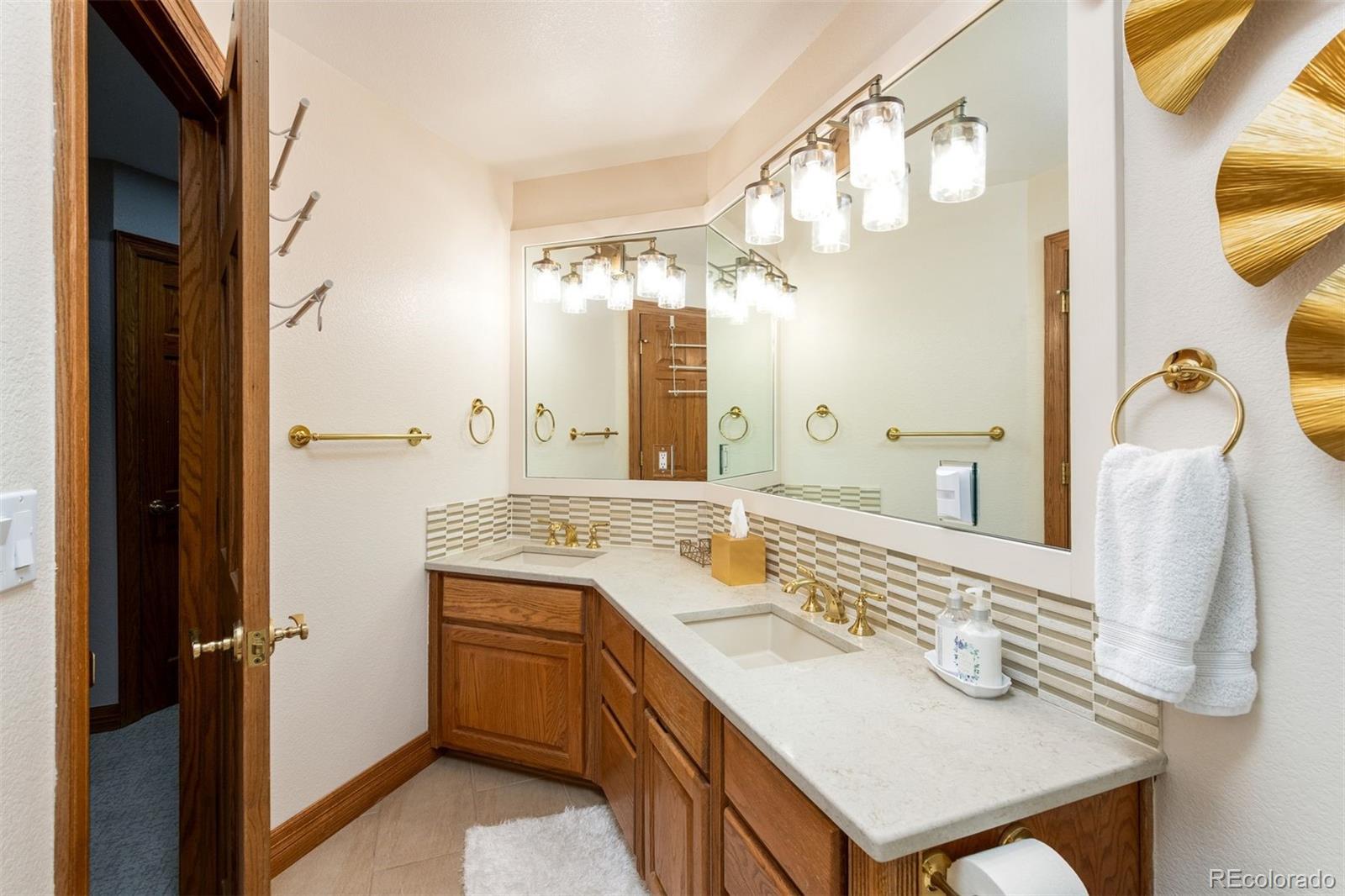 3935 Pierson Street Wheat Ridge, CO 80033 - Photo 32 of 50 a bathroom with a sink a vanity and a mirror
