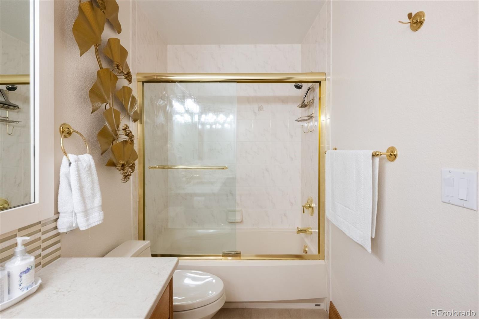 3935 Pierson Street Wheat Ridge, CO 80033 - Photo 33 of 50 a bathroom with a shower and a toilet
