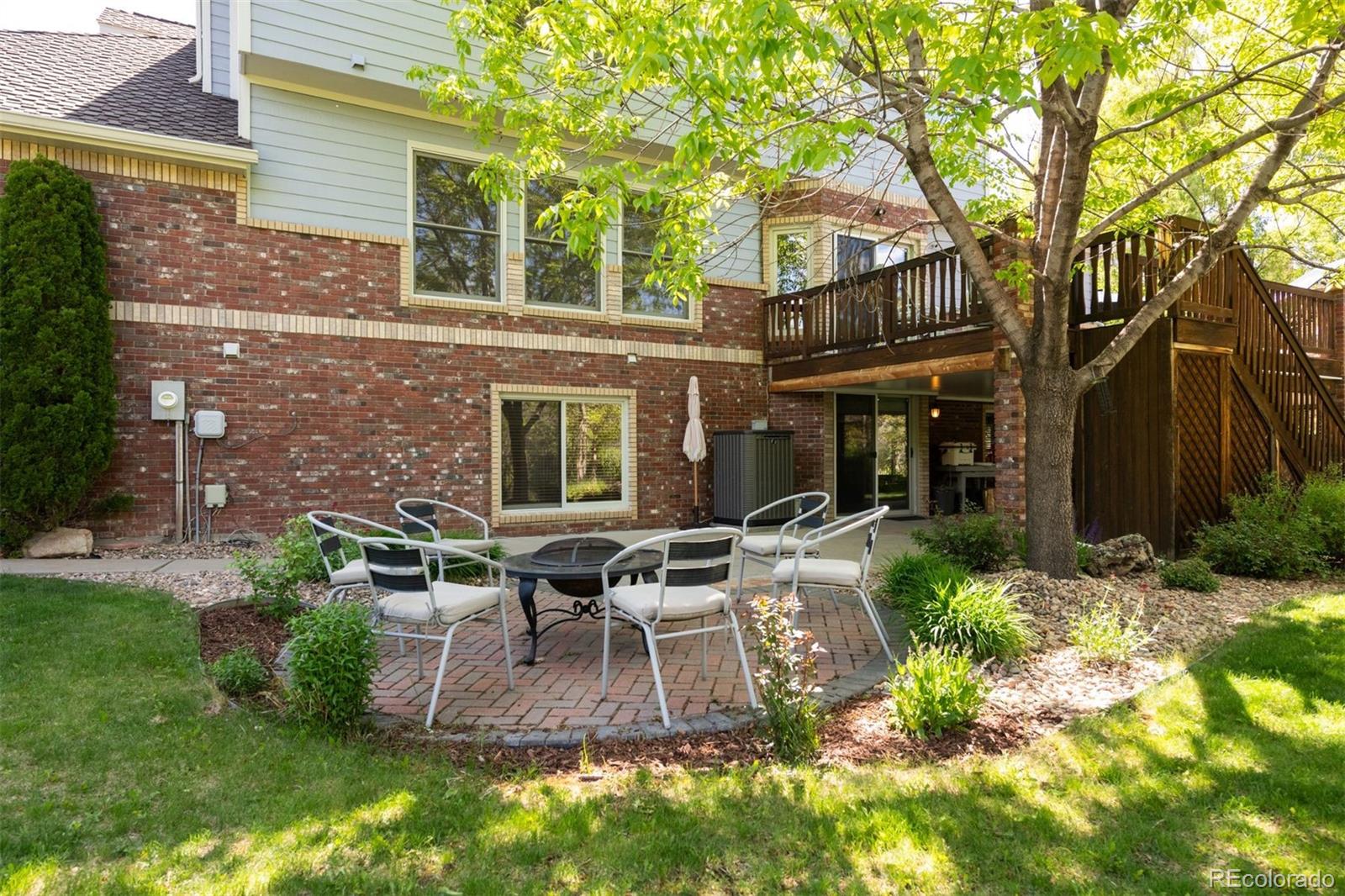 3935 Pierson Street Wheat Ridge, CO 80033 - Photo 45 of 50 a view of a patio with table and chairs potted plants and a large tree