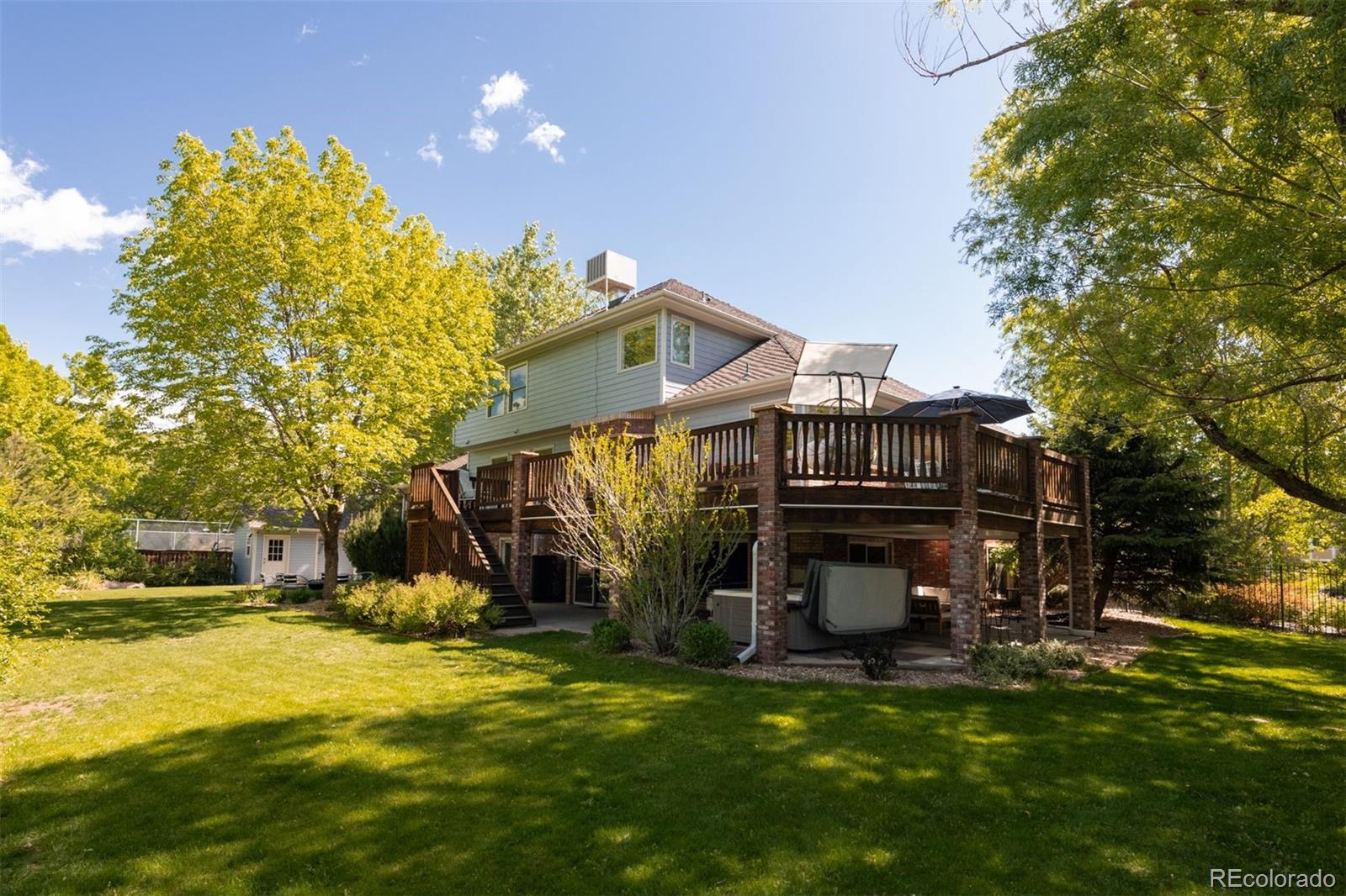 3935 Pierson Street Wheat Ridge, CO 80033 - Photo 8 of 50 a view of a house with a big yard