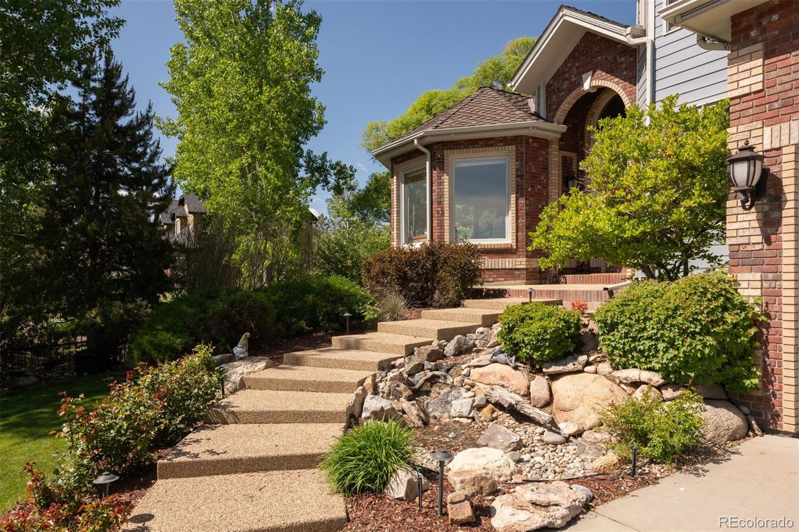 3935 Pierson Street Wheat Ridge, CO 80033 - Photo 10 of 50 a front view of a house with a yard