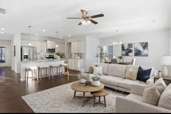 a living room with furniture kitchen view and a table