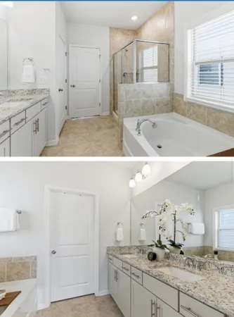 a bathroom with a granite countertop sink mirror and bathtub