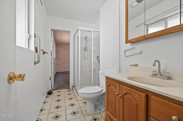 a bathroom with a toilet a sink and mirror