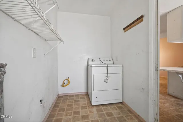 a view of a backyard with large trees and a small barn