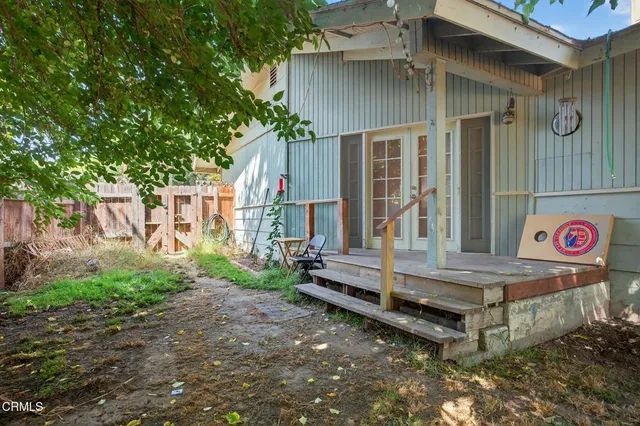 a view of a house with backyard and sitting area