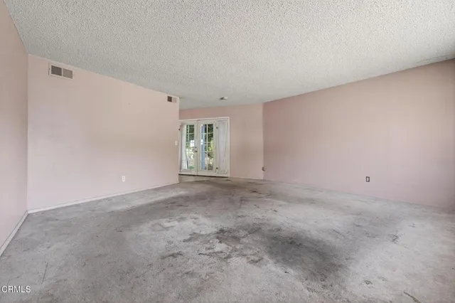 a view of kitchen with window and refrigerator