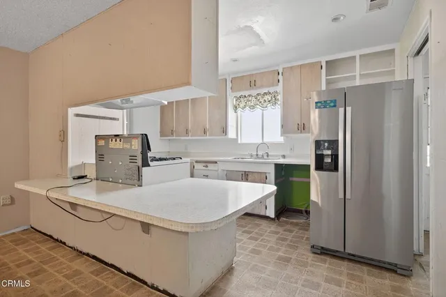 a kitchen with a sink stove and cabinets