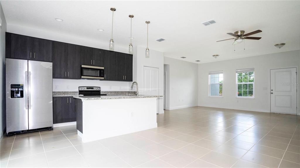 4147 Southwest 167th Street Ocala, FL 34473 - Photo 11 of 45 a kitchen with kitchen island a counter top space stainless steel appliances and a window