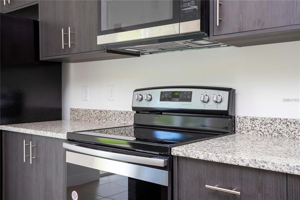 4147 Southwest 167th Street Ocala, FL 34473 - Photo 15 of 45 a kitchen with a stove and a microwave