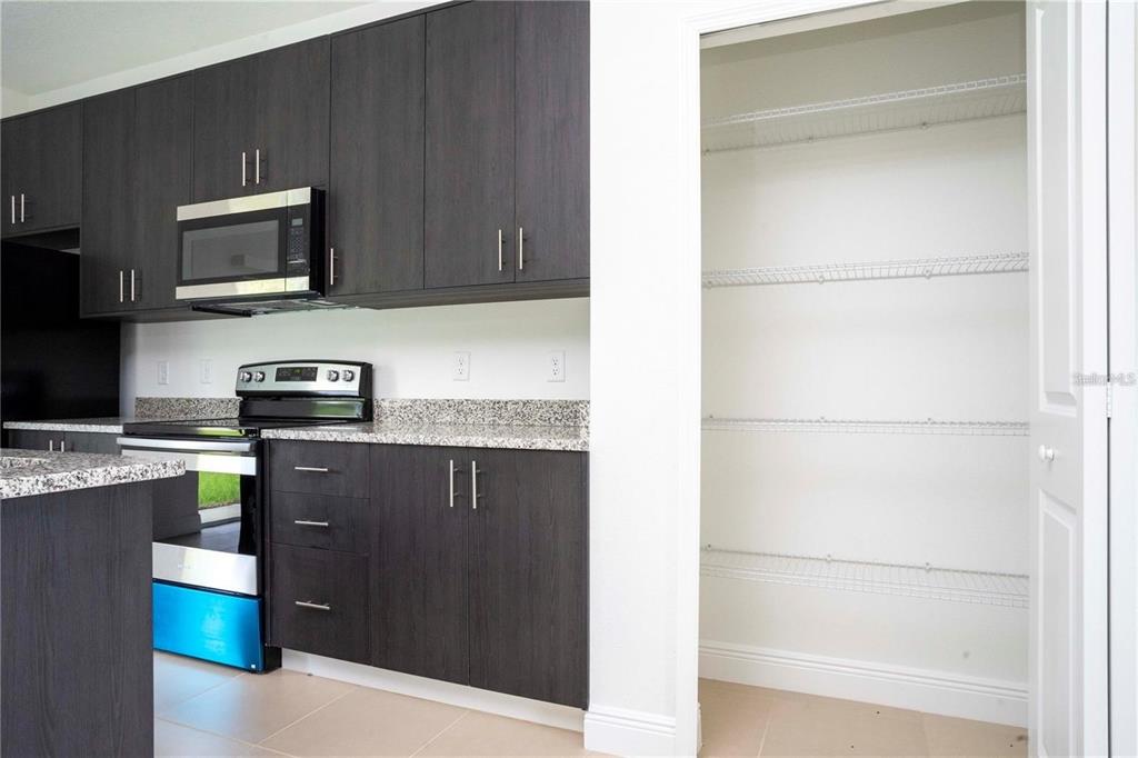 4147 Southwest 167th Street Ocala, FL 34473 - Photo 17 of 45 a kitchen with a refrigerator and a stove top oven