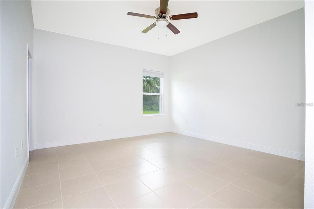 4147 Southwest 167th Street Ocala, FL 34473 - Photo 19 of 45 an empty room with a window and a ceiling fan