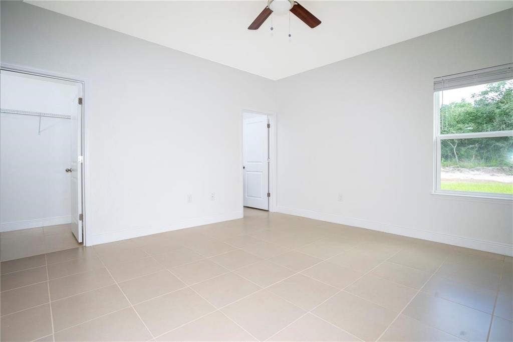 4147 Southwest 167th Street Ocala, FL 34473 - Photo 20 of 45 an empty room with a window and a ceiling fan