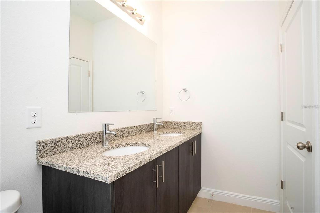 4147 Southwest 167th Street Ocala, FL 34473 - Photo 26 of 45 a bathroom with a granite countertop sink and a mirror
