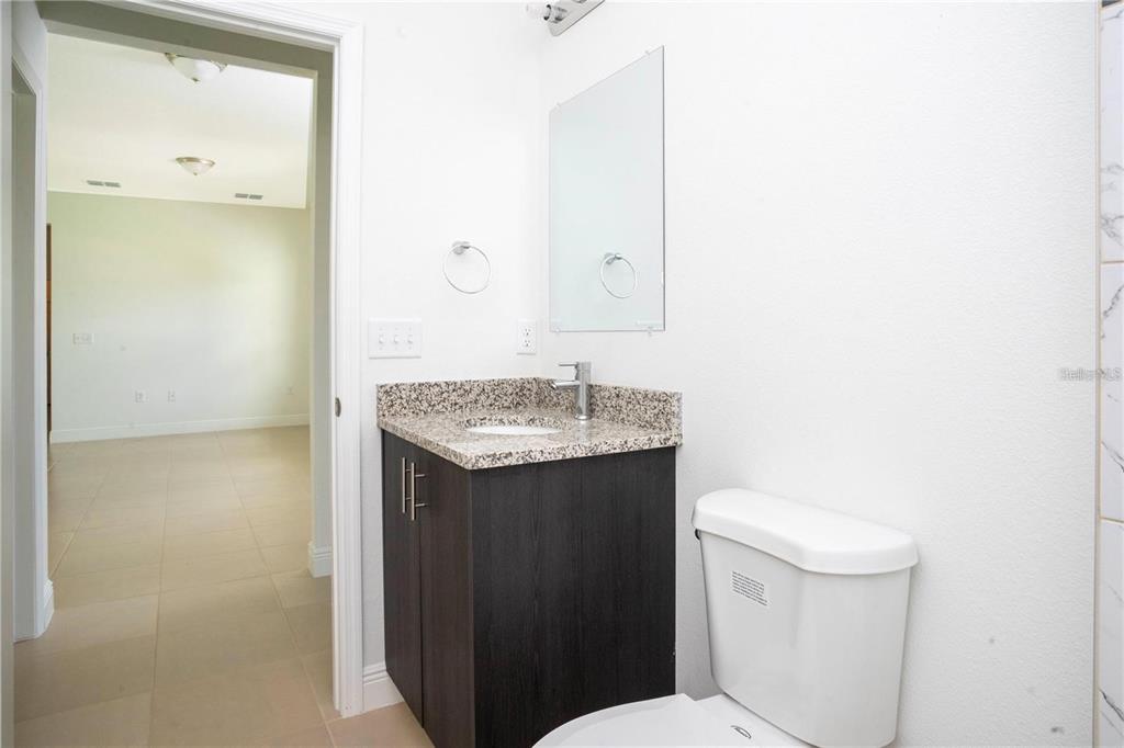 4147 Southwest 167th Street Ocala, FL 34473 - Photo 33 of 45 a bathroom with a granite countertop sink and a toilet