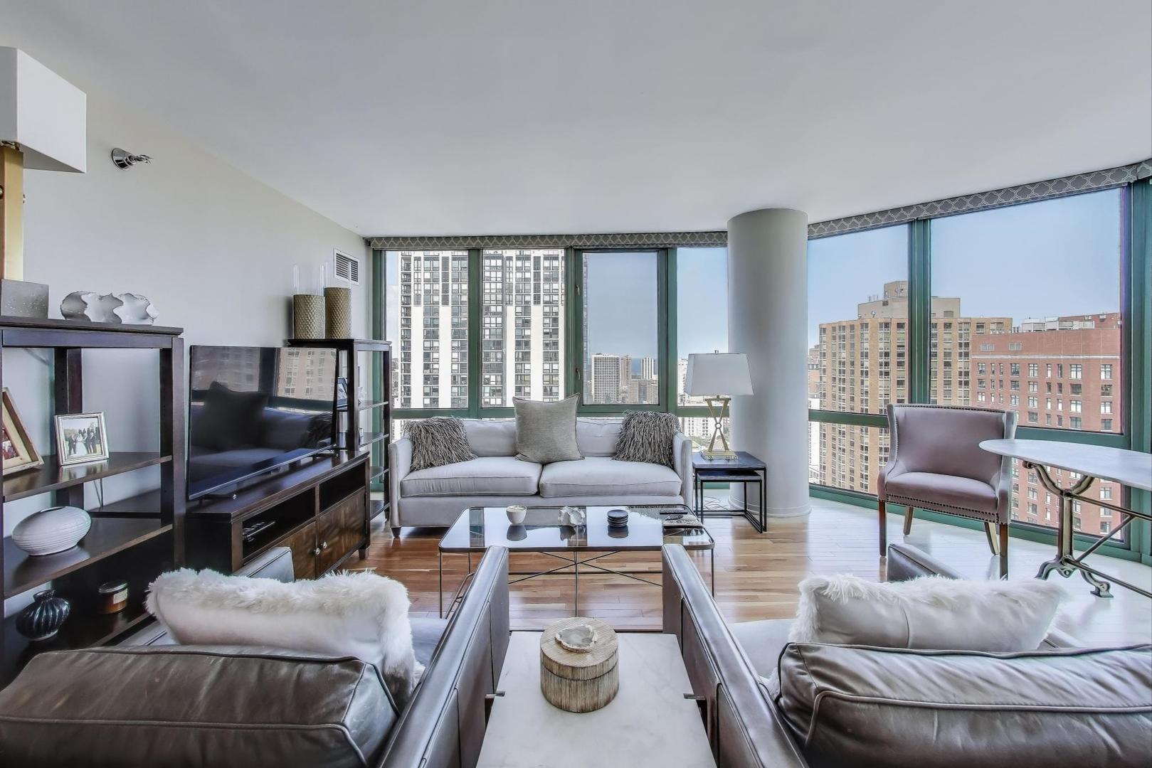 111 West Maple Street, Unit 2601 Chicago, IL 60610 - Photo 4 of 23 a living room with furniture and a flat screen tv