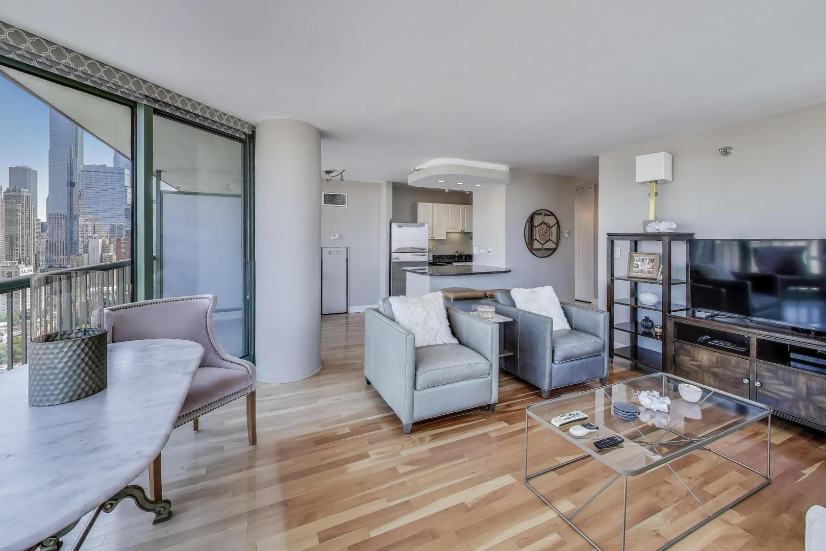 111 West Maple Street, Unit 2601 Chicago, IL 60610 - Photo 6 of 23 a living room with furniture and a wooden floor
