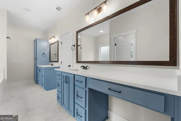 a bathroom with a double vanity sink mirror and a