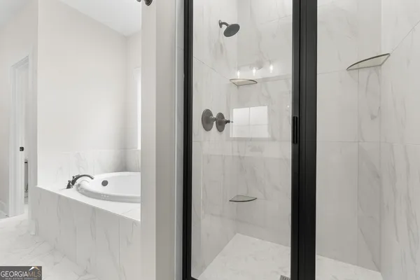a bathroom with a tub and shower