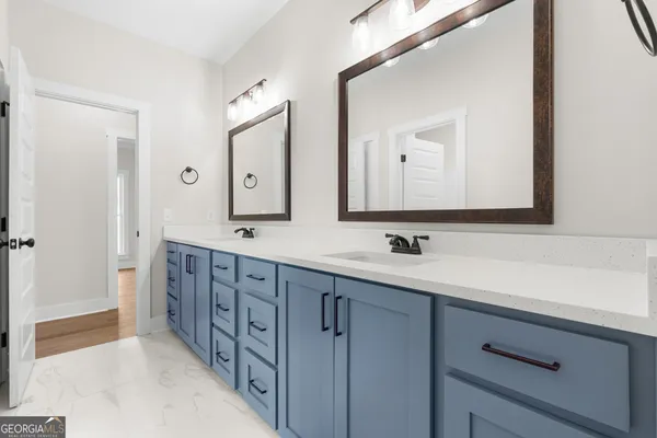 a bathroom with double sink and a mirror