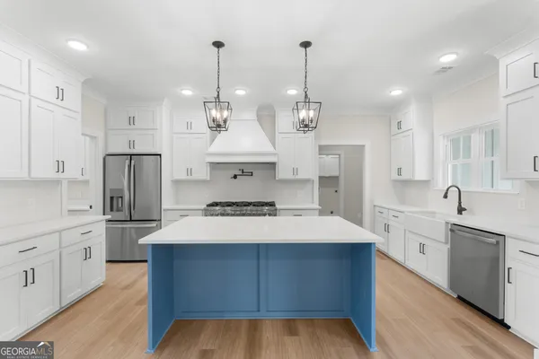 a large kitchen with stainless steel appliances kitchen island a large island in the center