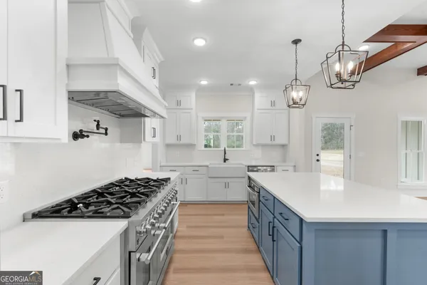 a kitchen with stainless steel appliances a sink stove and cabinets