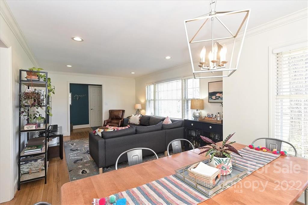 5638 Londonderry Road Charlotte, NC 28210 - Photo 12 of 44 a living room with furniture a chandelier and a table