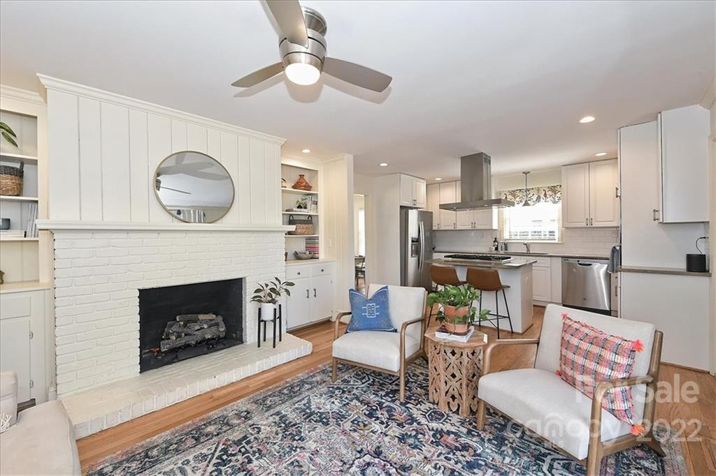 5638 Londonderry Road Charlotte, NC 28210 - Photo 14 of 44 a living room with furniture a fireplace and kitchen view