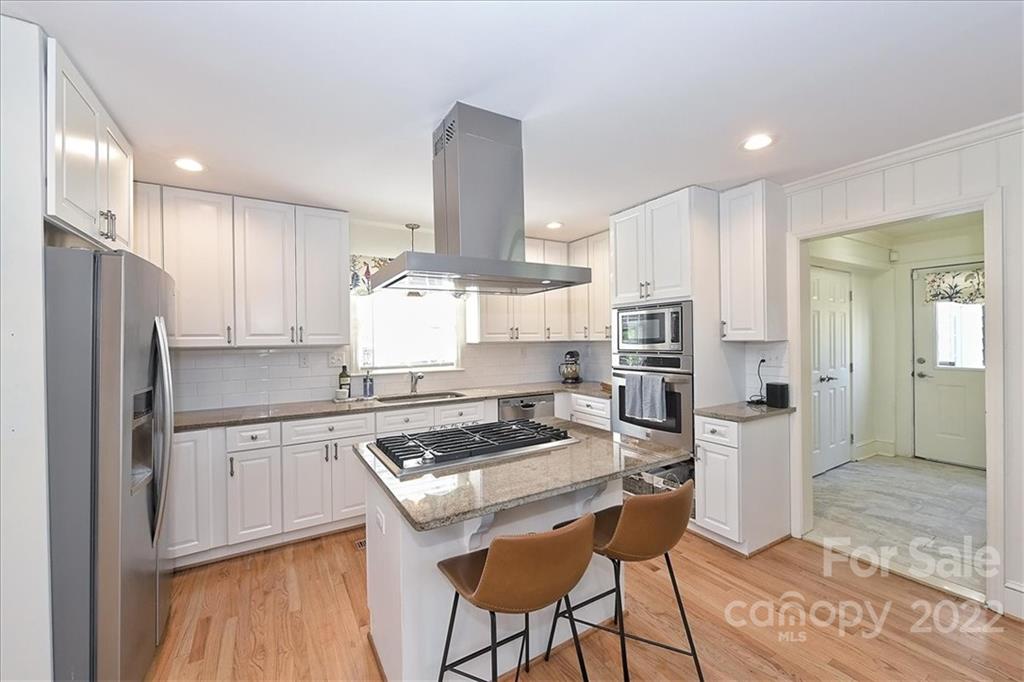 5638 Londonderry Road Charlotte, NC 28210 - Photo 19 of 44 a kitchen with stainless steel appliances granite countertop a stove refrigerator sink and cabinets