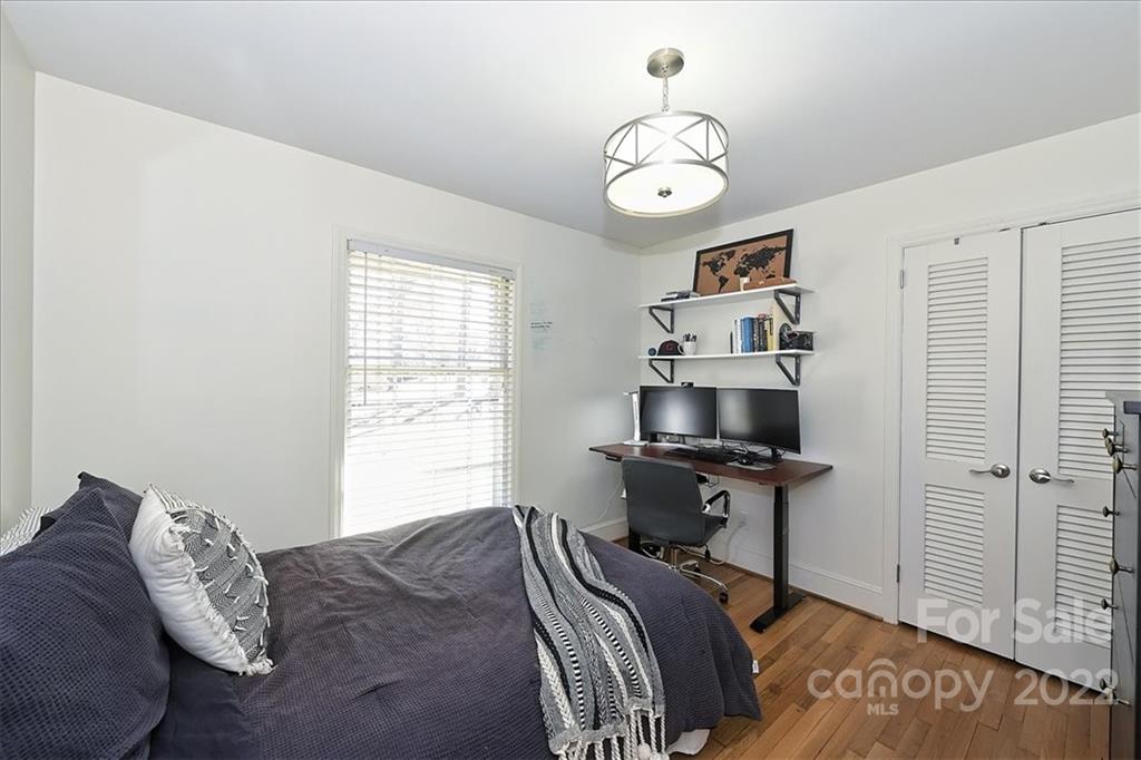 5638 Londonderry Road Charlotte, NC 28210 - Photo 27 of 44 a bedroom with a bed and a chandelier