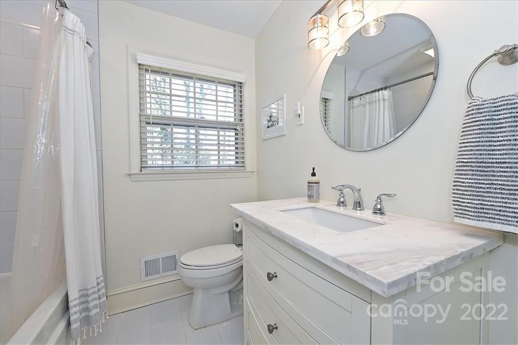 5638 Londonderry Road Charlotte, NC 28210 - Photo 30 of 44 a bathroom with a sink a toilet and a mirror