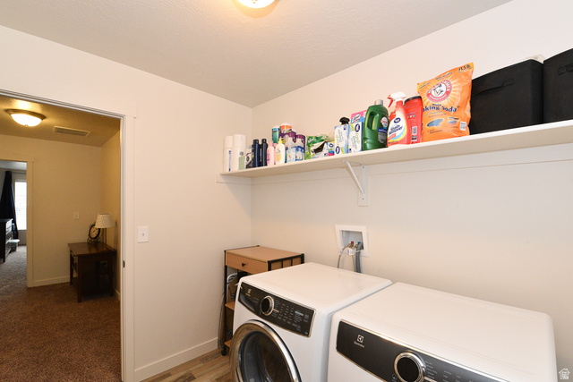 1632 North Apache Road Saratoga Springs, UT 84045 - Photo 26 of 28 Dedicated laundry area featuring a wall-mounted shelf, light-toned wall paint, and wood-finish flooring
