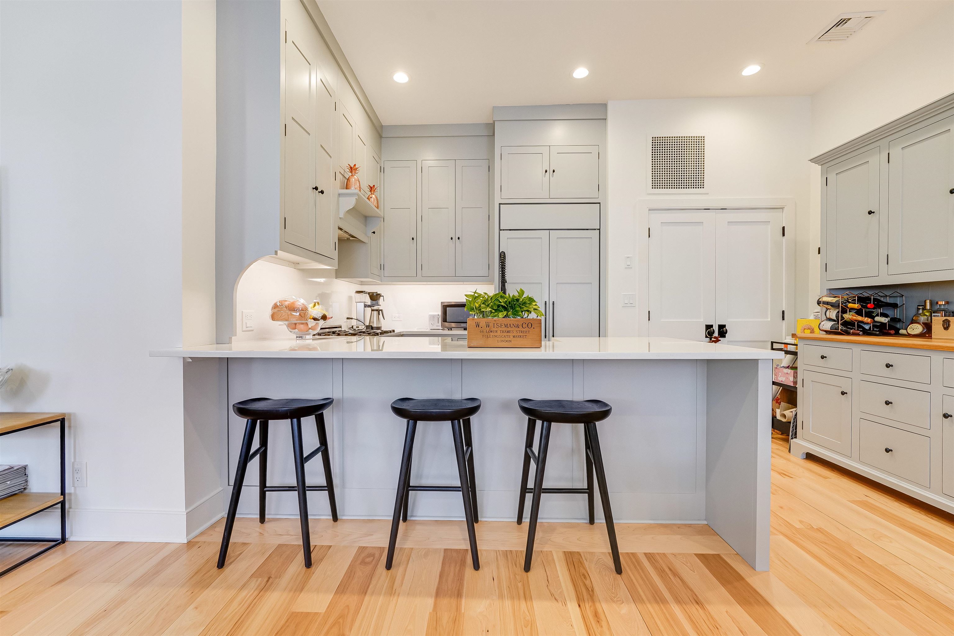 222 Clinton Street, Unit 19 Hoboken, NJ 07030 - Photo 12 of 31 a kitchen with stainless steel appliances granite countertop a stove a sink and white cabinets with wooden floor