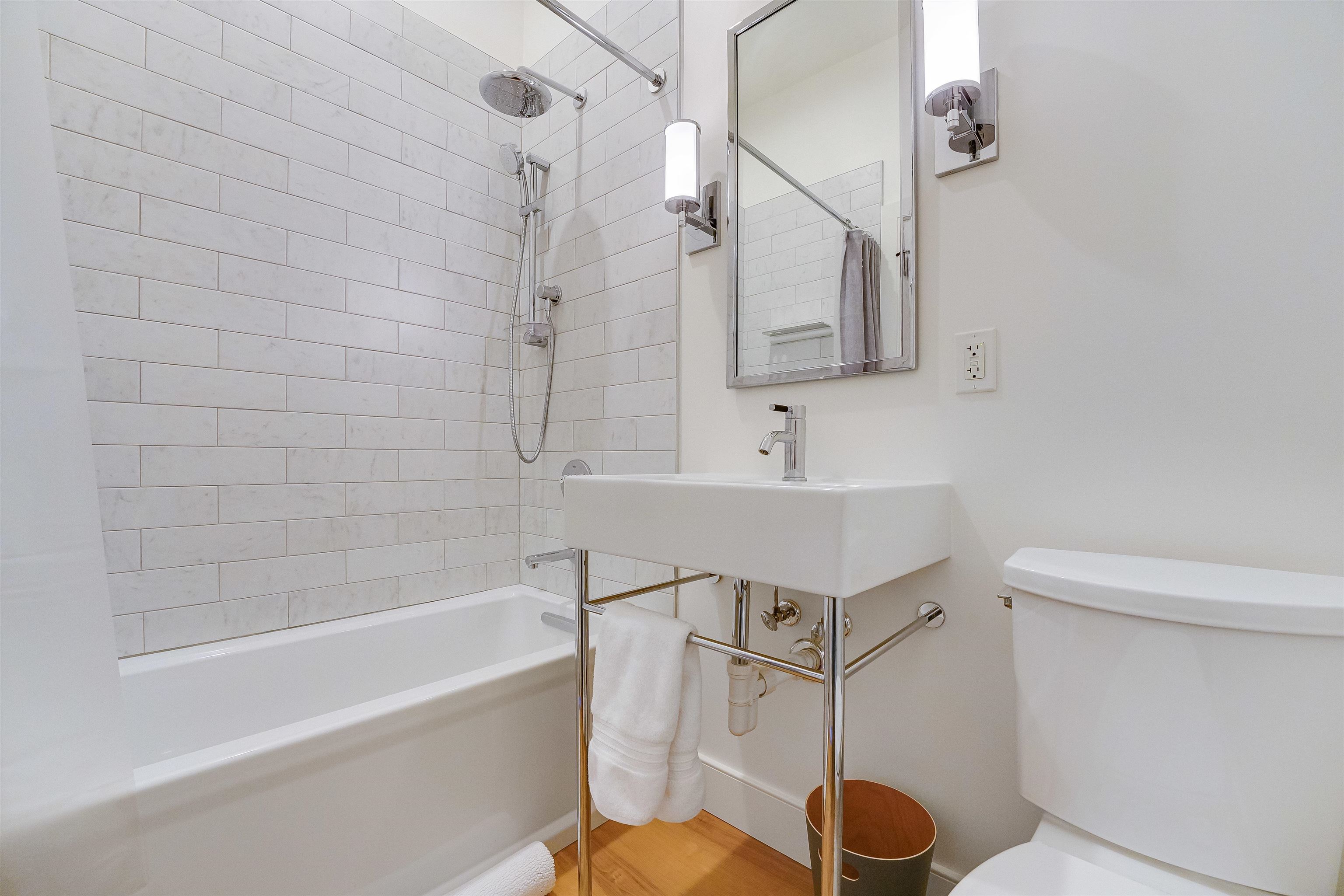 222 Clinton Street, Unit 19 Hoboken, NJ 07030 - Photo 24 of 31 a bathroom with a sink a toilet and bathtub