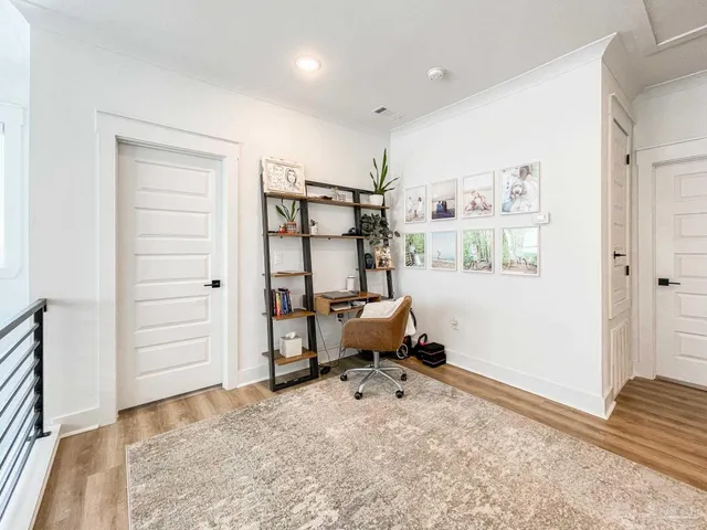 a view of a workspace with furniture and a window
