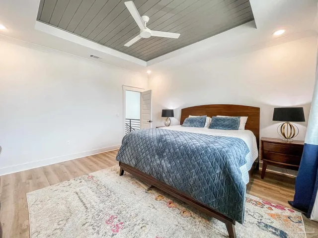 a bedroom with a bed and a night stand