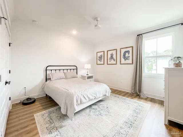 a bedroom with a large bed and a window