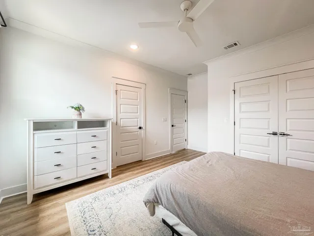 a bedroom with a bed and a dresser