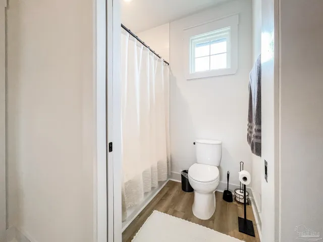 a bathroom with a toilet and a shower