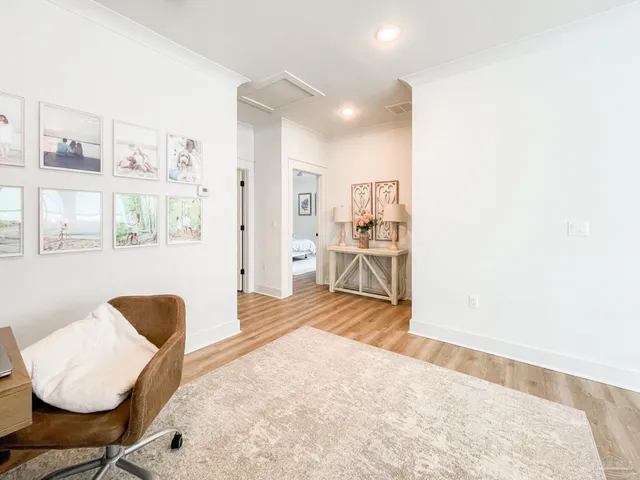 a bedroom with furniture and a large window
