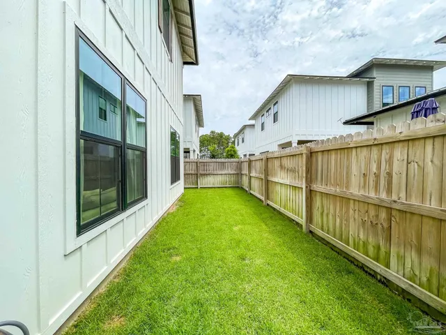 a view of backyard with deck and garden