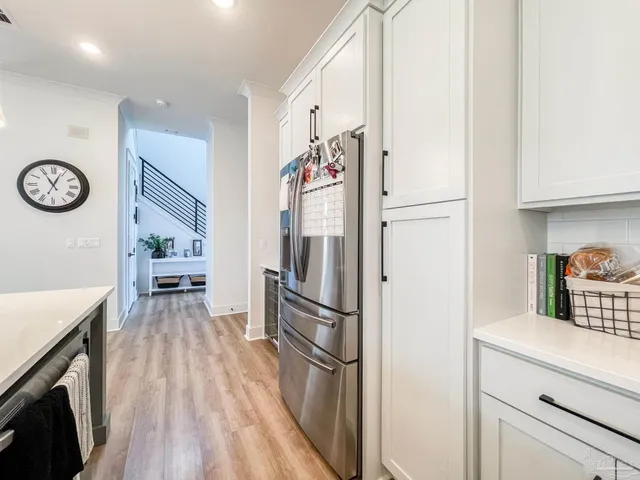 a kitchen with a refrigerator and a stove top oven