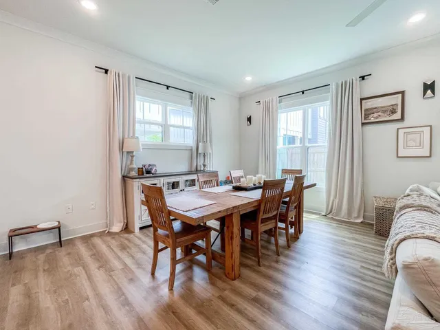 a view of a dining room with furniture window and wooden floor