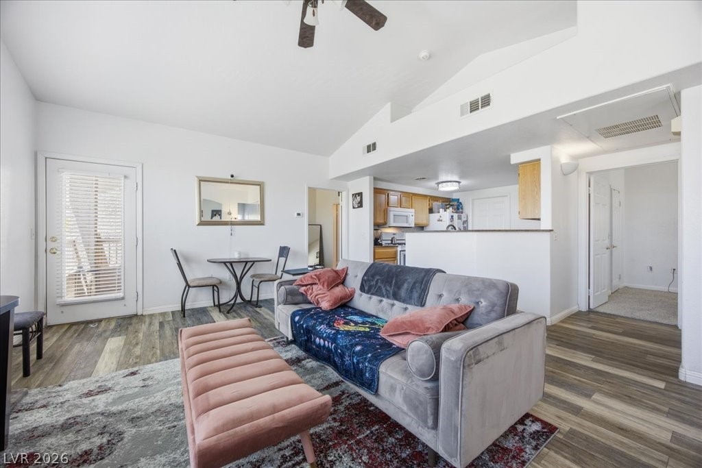 10550 West Alexander Road, Unit 2164 Las Vegas, NV 89129 - Photo 6 of 27 An inviting open-concept layout unites the living room, dining area, and kitchen, creating a harmonious flow.