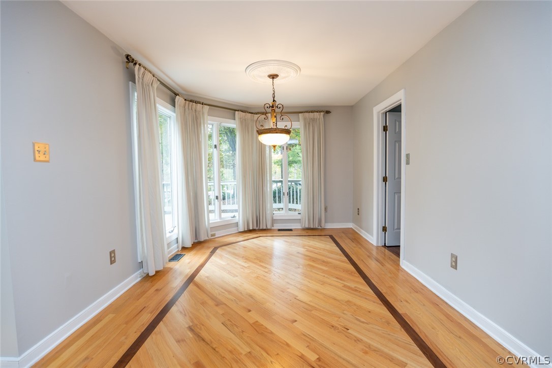 3103 E Stony Point Road, Unit END Richmond, VA 23235 - Photo 21 of 50 a spacious bedroom with a bed and a chandelier