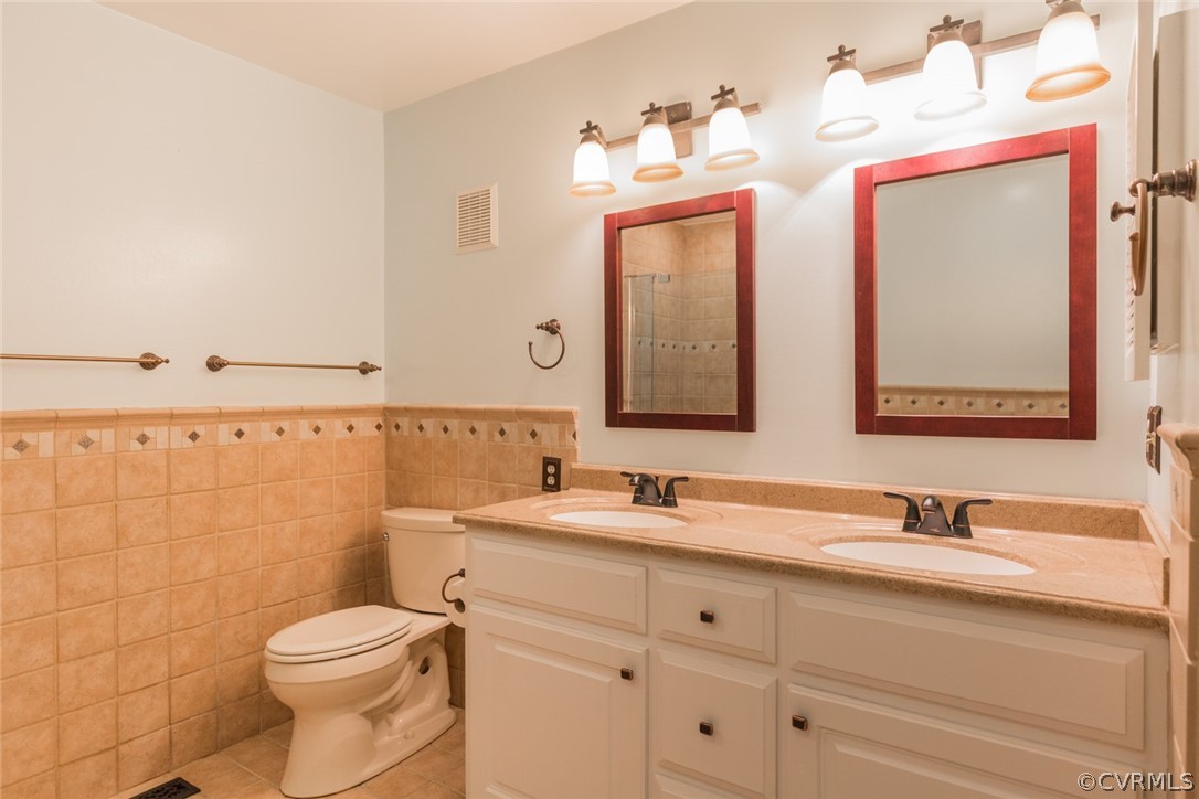 3103 E Stony Point Road, Unit END Richmond, VA 23235 - Photo 34 of 50 a bathroom with a double vanity sink mirror and toilet